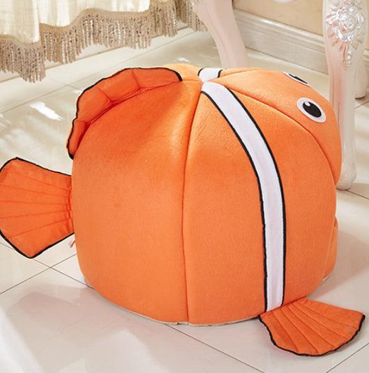 Orange fish-shaped bean bag on a tiled floor