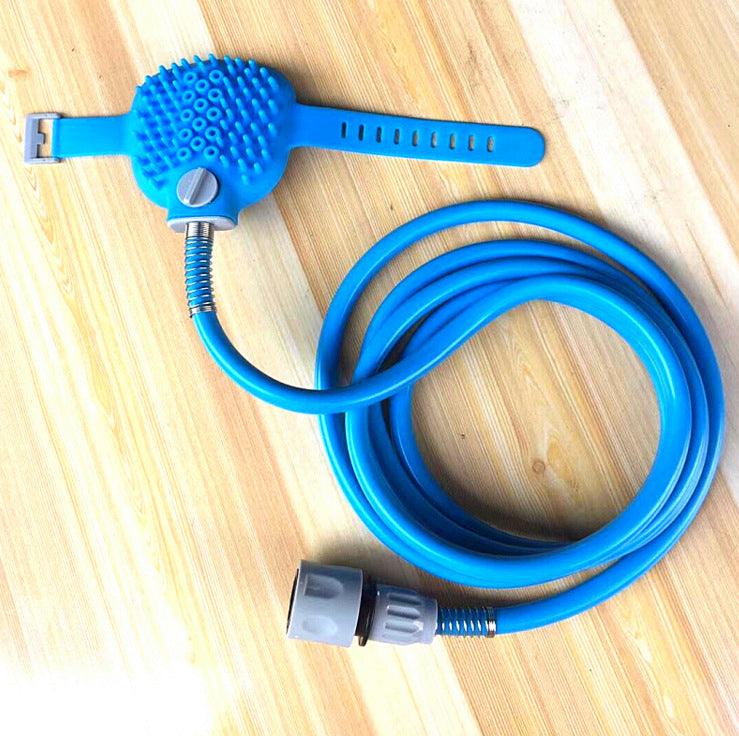 Blue pet grooming tool with a hose on a wooden surface