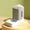 Modern dog water fountain on a gold stand with a green background