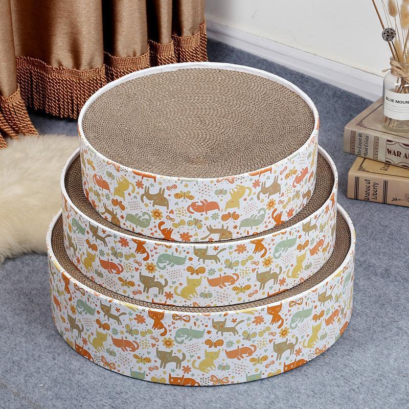 Set of three round cat scratchers with animal pattern on a carpeted floor.