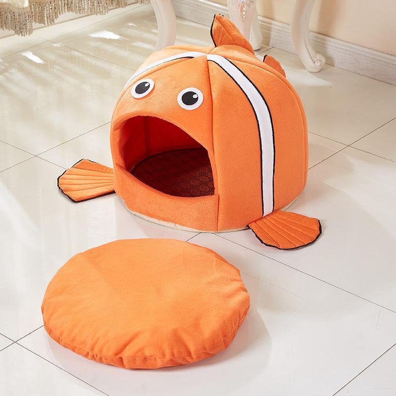 Orange fish-shaped pet bed on a tiled floor