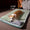Dog lying on a green pet bed in a cozy room with books and a chair.