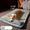 Dog lying on a green pet bed with a plush toy in a cozy room.