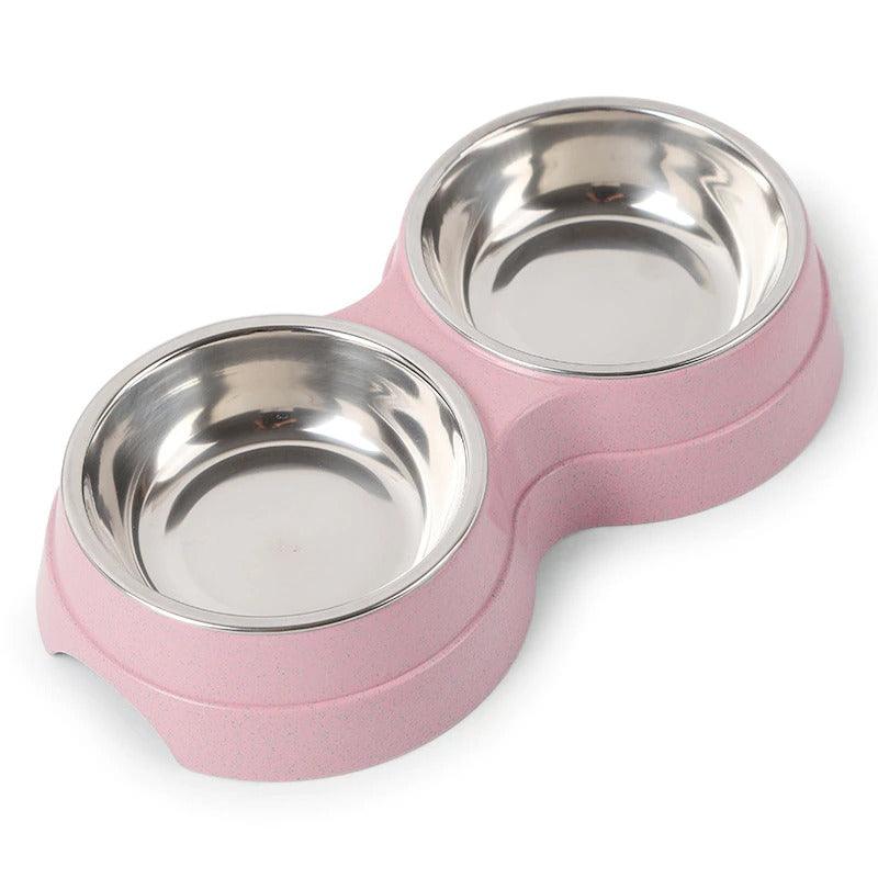 Pink pet bowl with two stainless steel compartments on a white background