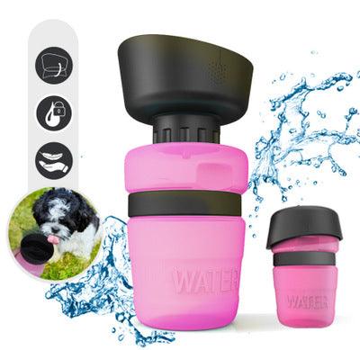 Pink water bottle with black cap on a white background, surrounded by water splashes and a dog image.