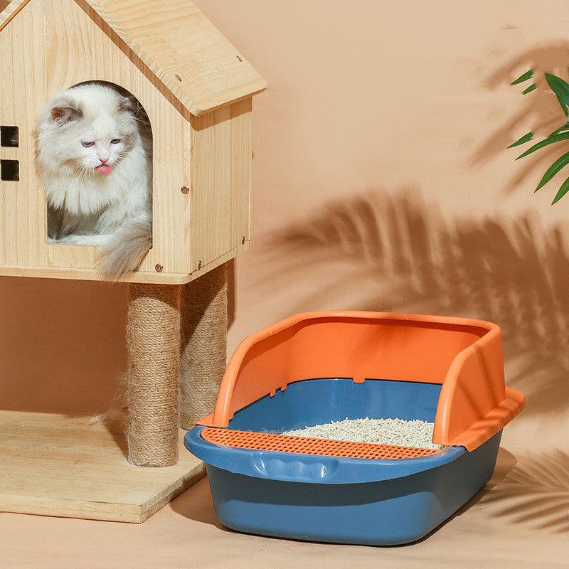 Cat sitting in a wooden house with an orange and blue litter box on a beige background