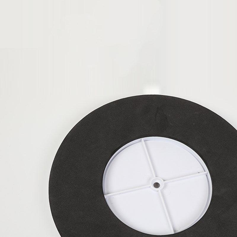 Black wheel cover with a white center on a light gray background