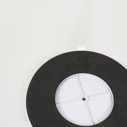 Black wheel cover with a white center on a light gray background