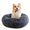 Dog sitting on a fluffy gray pet bed with a white background