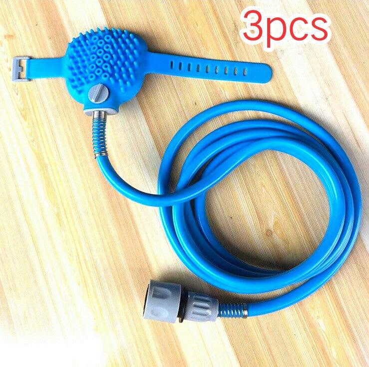Blue pet grooming tool with a coiled hose on a wooden surface, labeled '3pcs'.