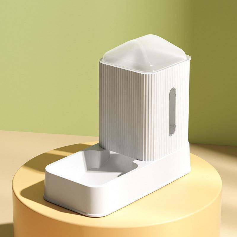 White and gray electronic device on a gold stand with a green background
