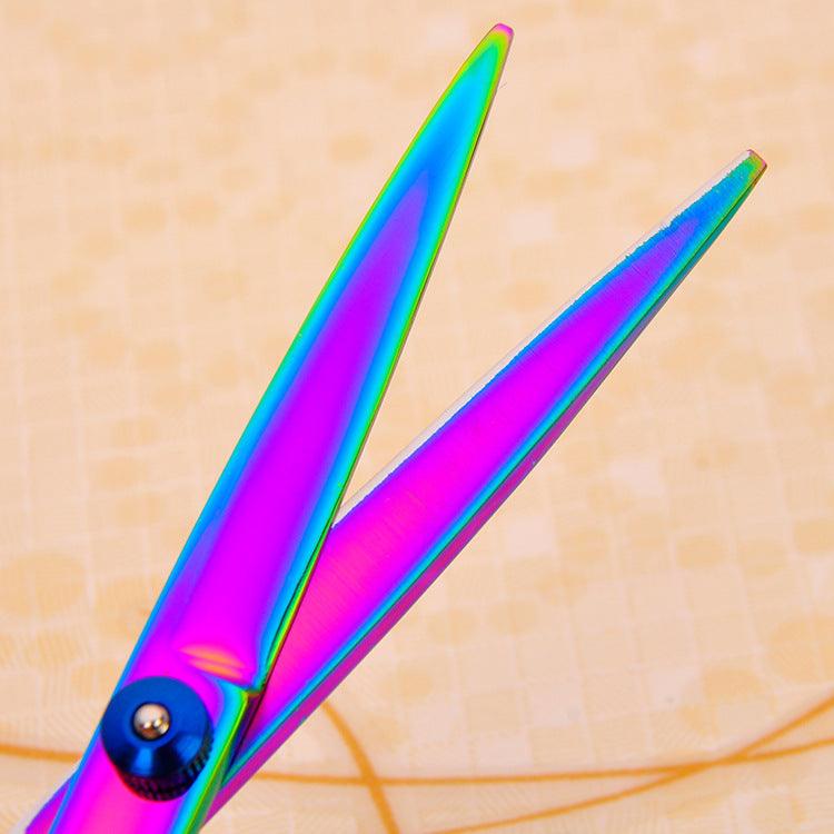 Colorful scissors on a beige background