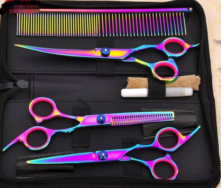 Set of colorful hairdressing scissors and comb in a case on a wooden surface