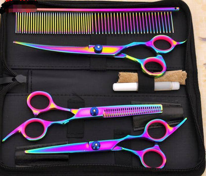Set of colorful hairdressing scissors and comb in a case on a wooden surface