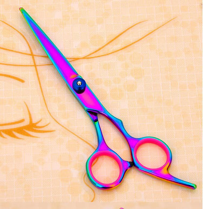 Multicolored scissors on a textured beige background