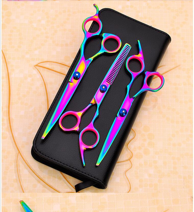Set of colorful scissors in a black case on a beige background