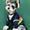 Dog wearing a colorful sweater on a green background