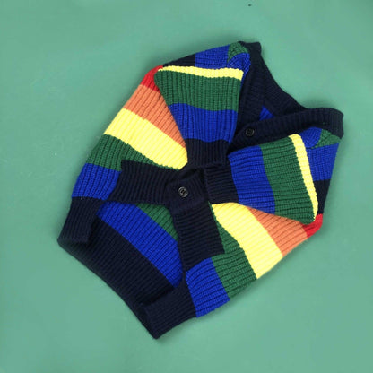 Colorful striped sweater on a green background