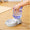 Pet water dispenser with a hand lifting the water bottle on a wooden floor.