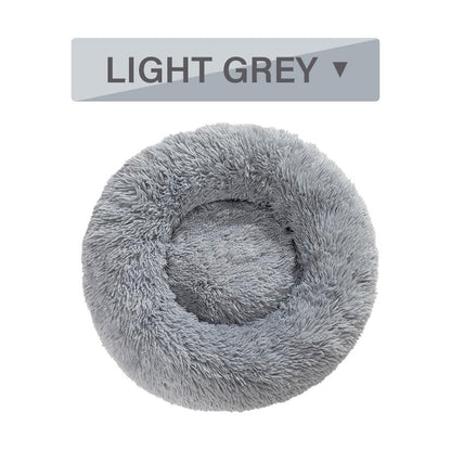 Light gray fluffy pet bed with a label indicating the color on a white background