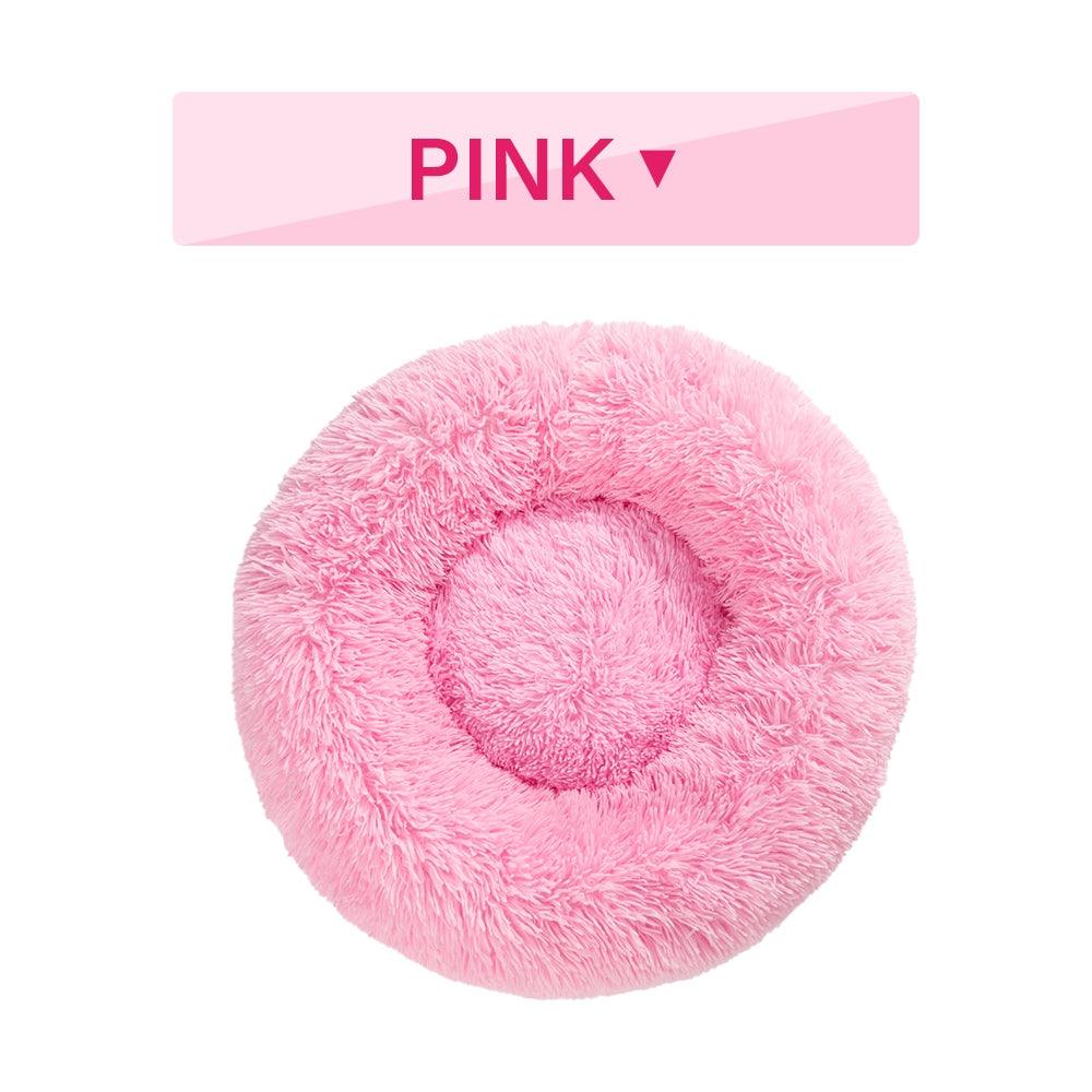 Pink fluffy donut pet bed with 'PINK' label on a white background