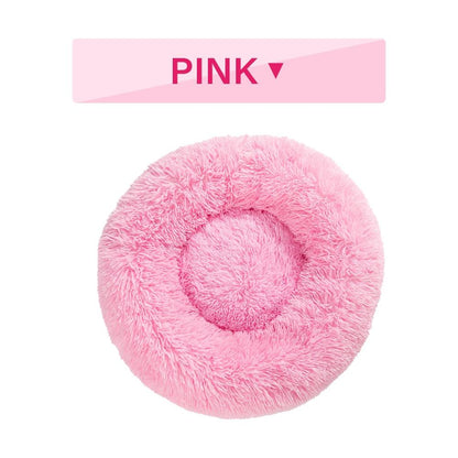 Pink fluffy donut pet bed with 'PINK' label on a white background