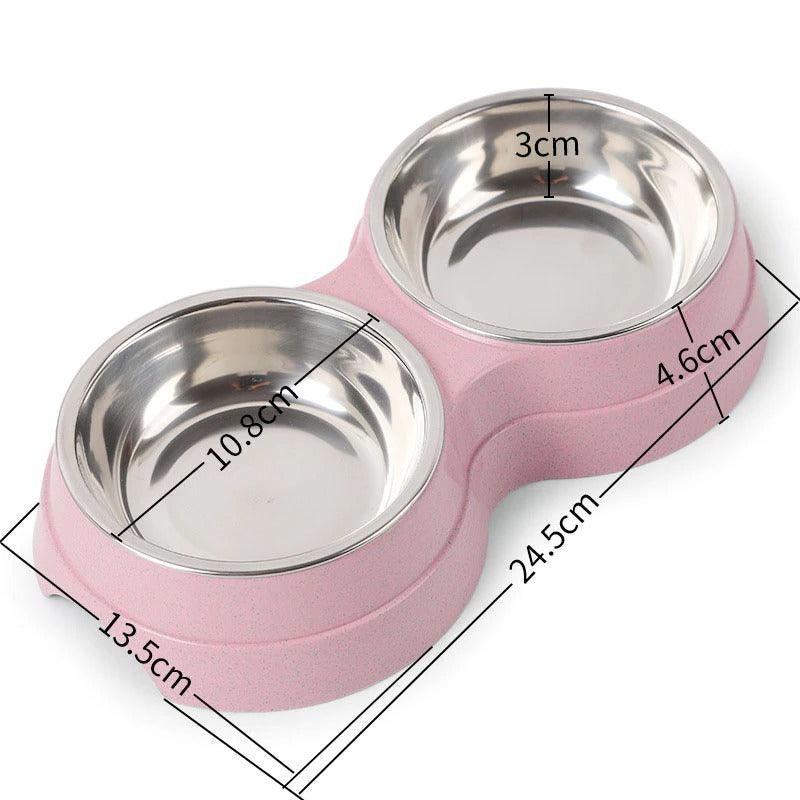Pink pet bowl with two stainless steel compartments and measurements on a white background