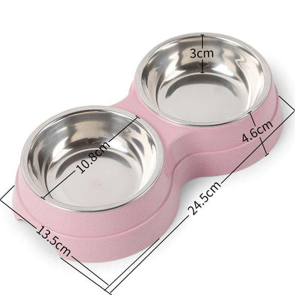 Pink pet bowl with two stainless steel compartments and measurements on a white background