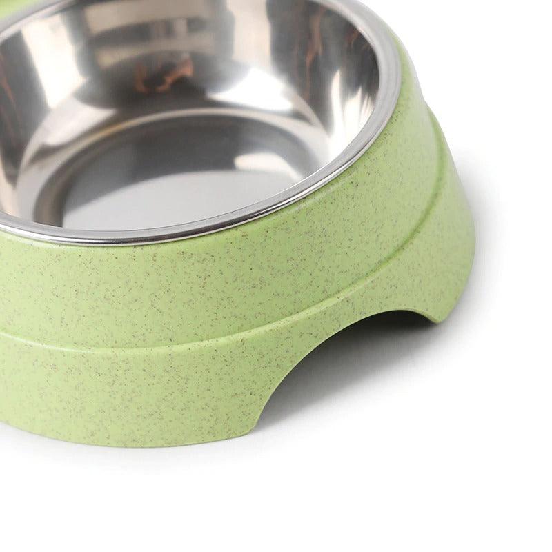 Green pet bowl with stainless steel interior on a white background