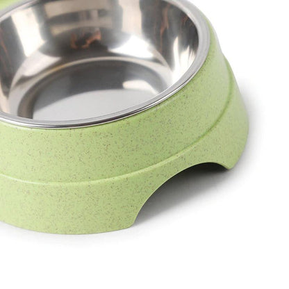 Green pet bowl with stainless steel interior on a white background
