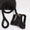 Black dog harness and leash set on a white background