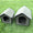 Two gray pet houses on a grassy background