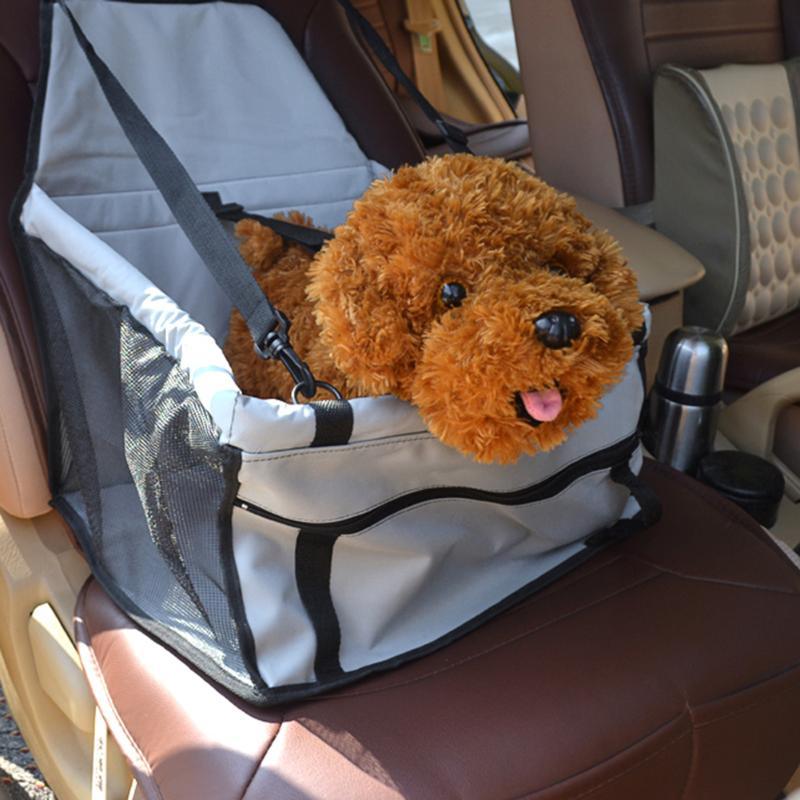 Dog in a pet seat cover inside a car