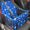 Blue pet seat cover with paw prints and bones pattern on a car seat