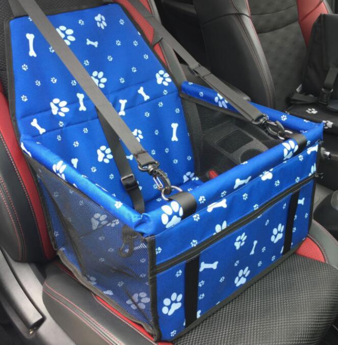 Blue pet seat cover with paw prints and bones pattern on a car seat