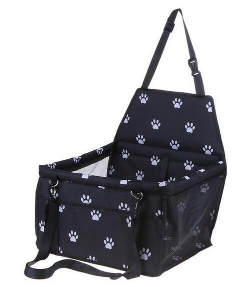 Black pet carrier with white paw prints on a white background