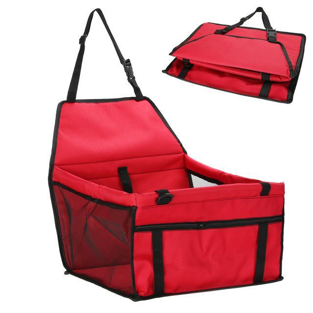 Red pet carrier with black straps on a white background